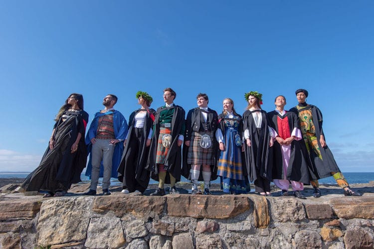 A group of graduates from the University of St Andrews in national dress on the Pier following Graduation