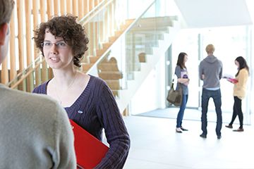 Students and people talking in a lobby area