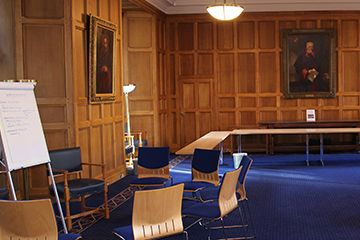 Chairs arranged around a flip board in College Gate