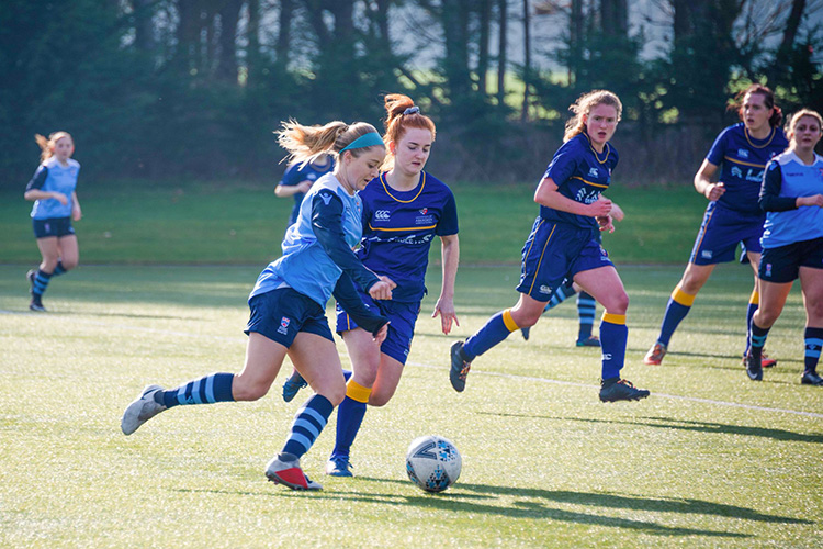 women playing football