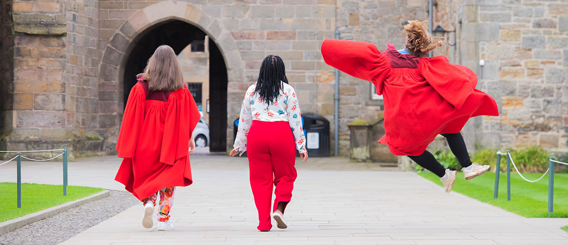students in red gowns in st marys quad