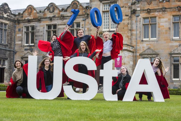 Students holding letters in the quad