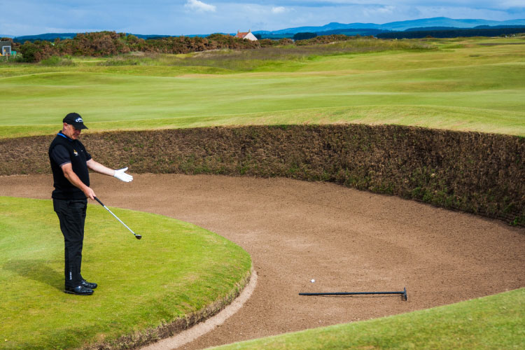 Golfer looking into a bunker