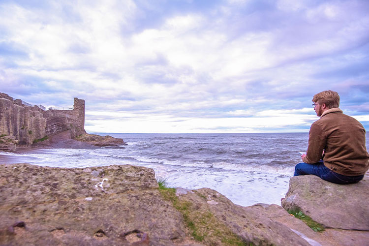 Student looking toward the sea