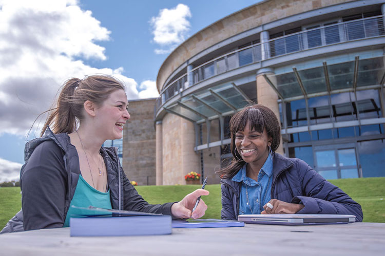 Two women talking outside