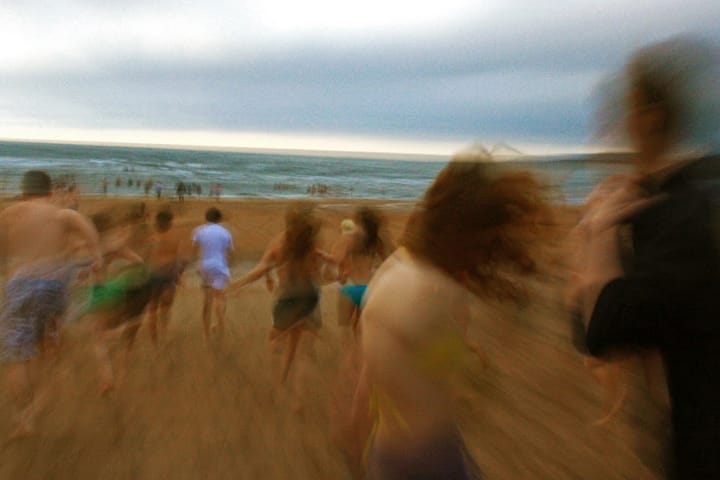 Students running into the North Sea for the May Dip