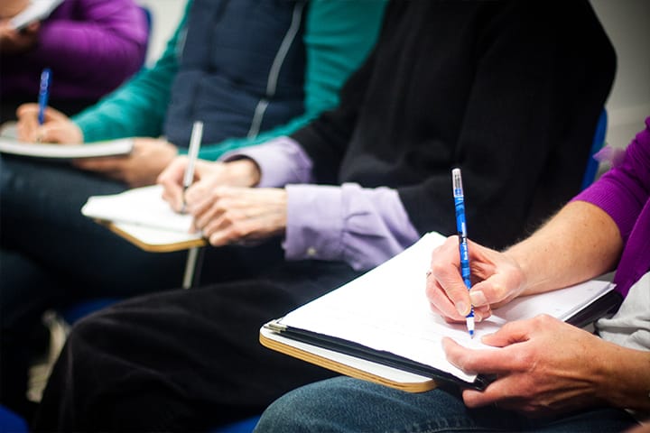Students taking notes in a lecture