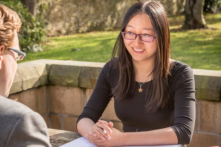 Student sitting talking with an advisor