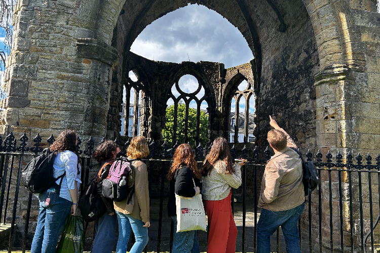 students looking at historical building in st andrews