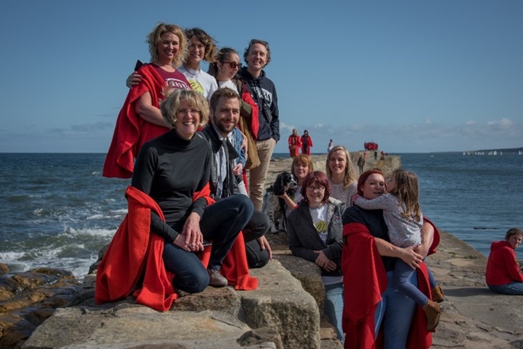 Group of students of varying ages on St Andrews pier
