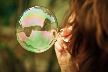 Child blowing bubbles - activities for children