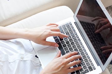 Person typing on a Macbook