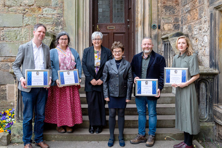 Teh four winners of the 1413 Teaching Excellence Awards stood with the Principlal in St Mary's Quad.