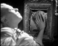 Still from 'Beauty and Beast' (1946, Jean Cocteau), showing Belle turning away from a mirror