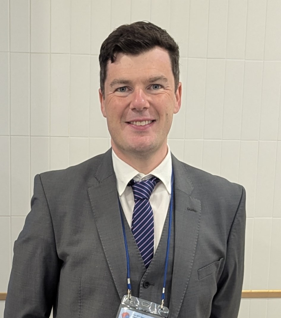 Person in suit smiling