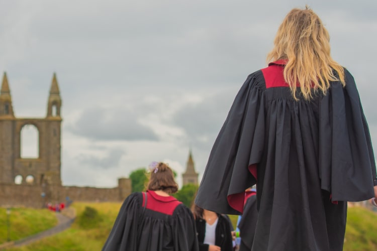 Postgraduate student walking along St Andrews pier