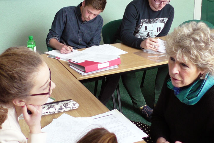 Small student group talking to lecturer
