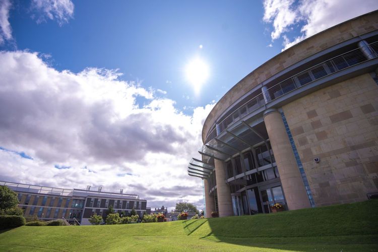 Gateway building against a blue sky with the sun