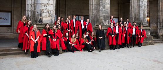 A choir standing in front of a chapel