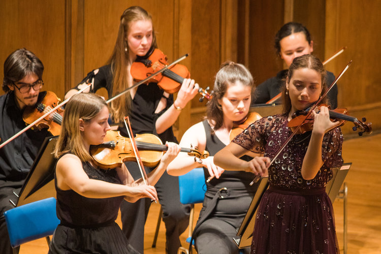 Students playing in a strings group