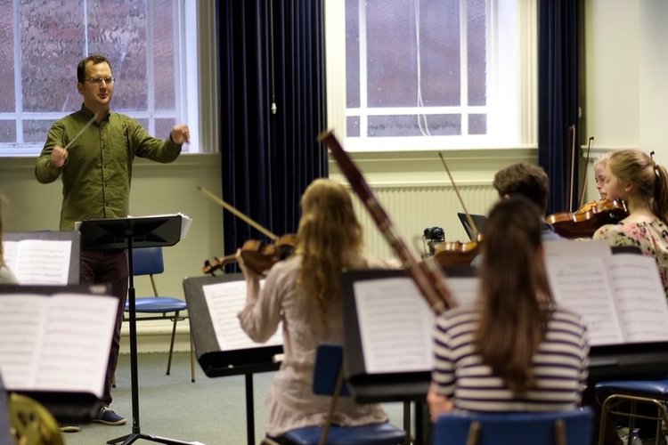 A small music group being conducted