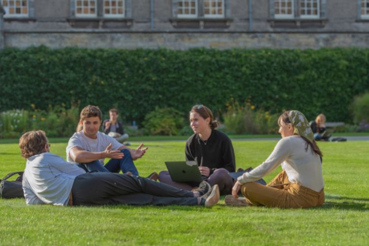 Students sitting on the grass talking