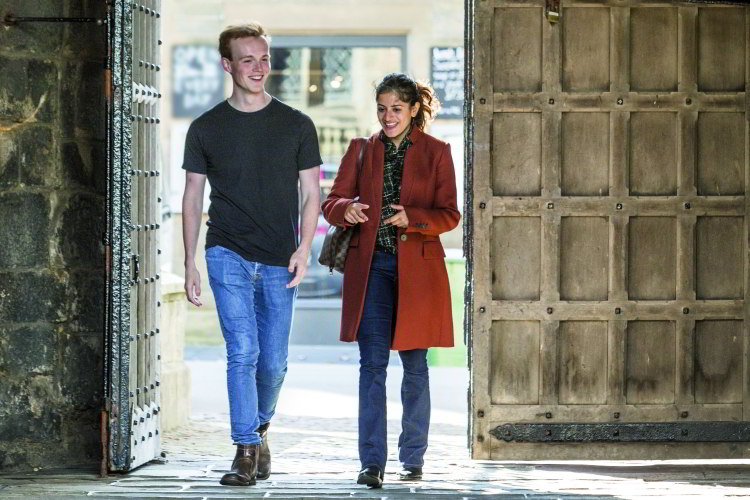 Students passing through an archway
