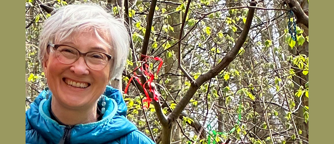Mindy Grewar, smiling, outdoors on a sunny day