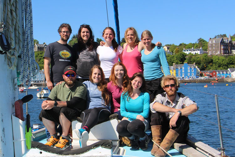 Masters students sitting on a boat