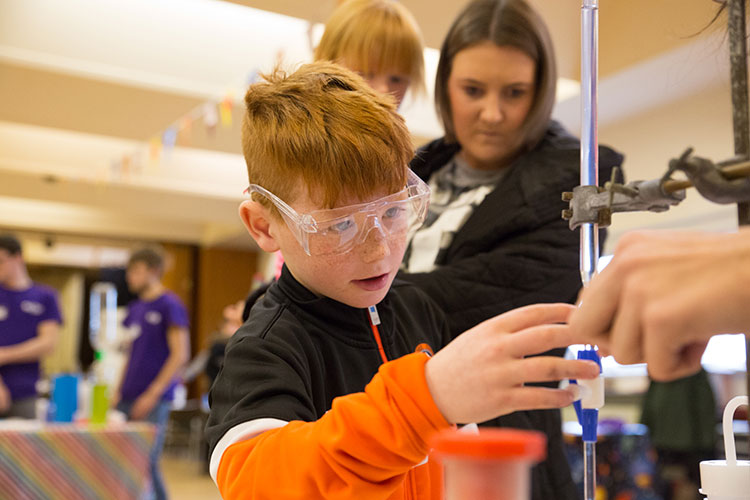 Young boy partaking in a chemistry experiment