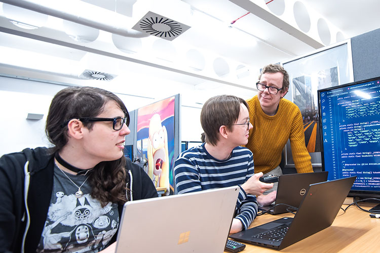A lecturer helping studnets in the lab
