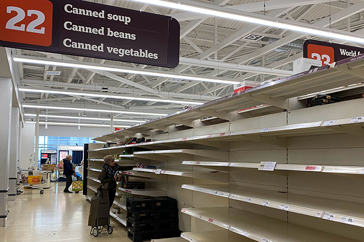 empty supermarket shelves - photo by John Cameron on Unsplash