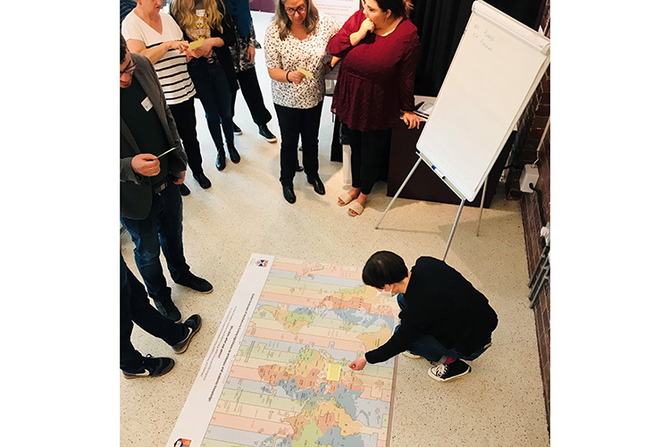 people gathered around a large map of the world