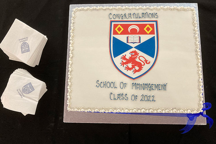 large cake decorated with University of St Andrews crest and words, Congratulations School of Management Class of 2022
