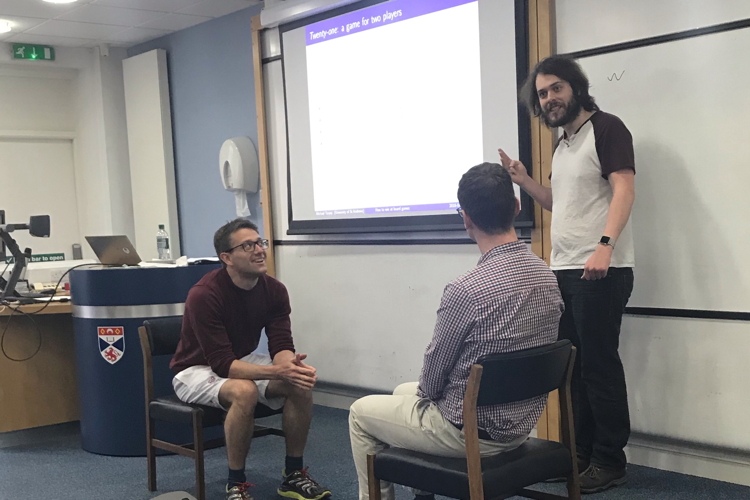 Three students participating in a postgraduate seminar