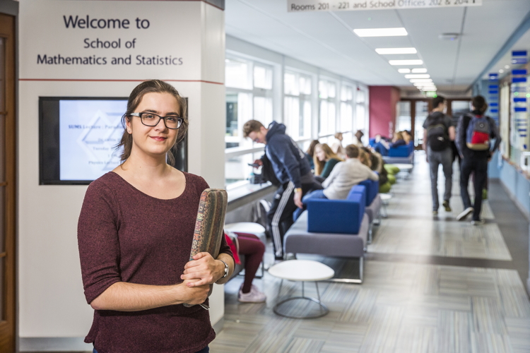 Student in foyer of Mathematical Institute 