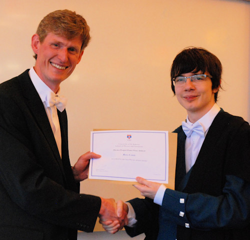 Head of School presents the prize for best poster to Ross Cowie.