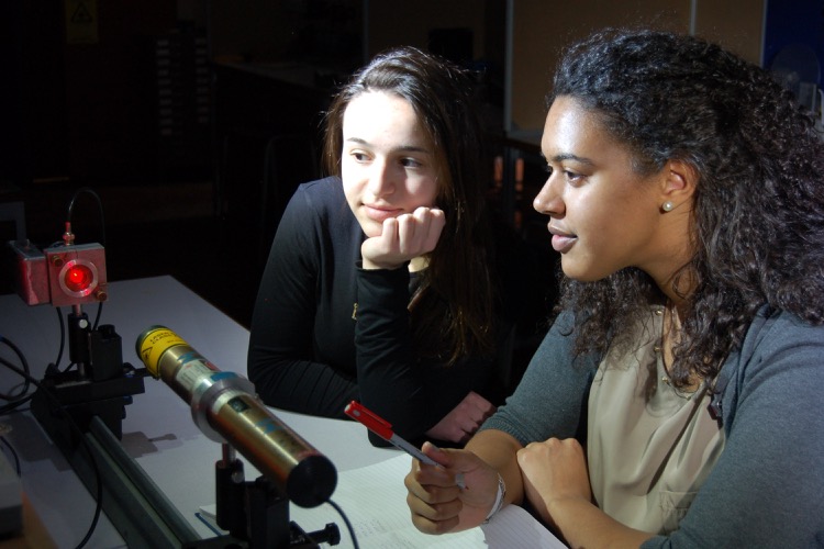 Two students working in an optics lab.