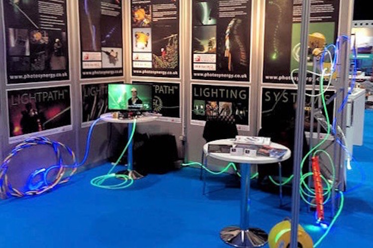 Exhibition photo from Lightpath Technology showing flexible lit-up cables.
