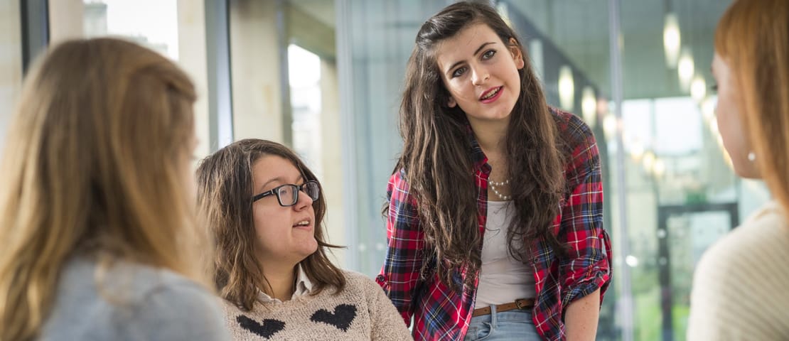 A group of female students having a conversation at a table