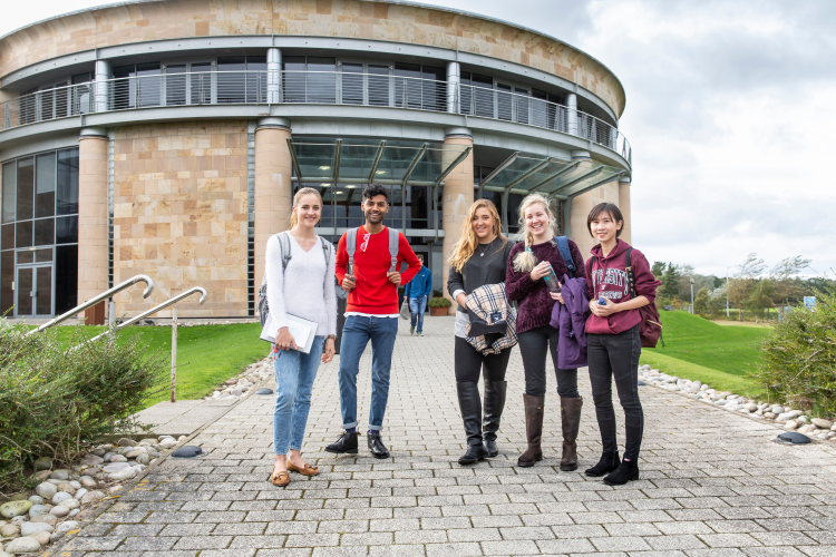 Students stand in front of the Gateway Building in St Andrews