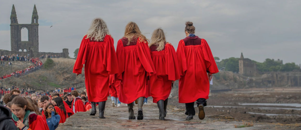Red gowns on pier