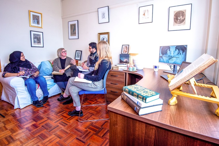 Students chat in a seminar room