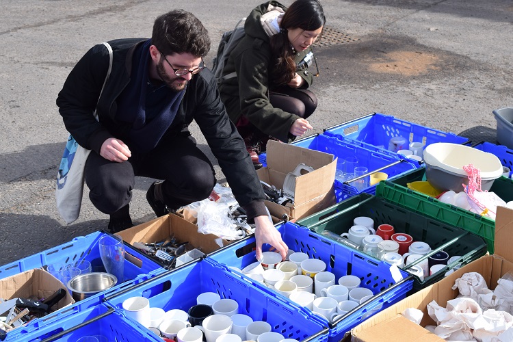 Students at big giveaway finding secondhand kicthenware.