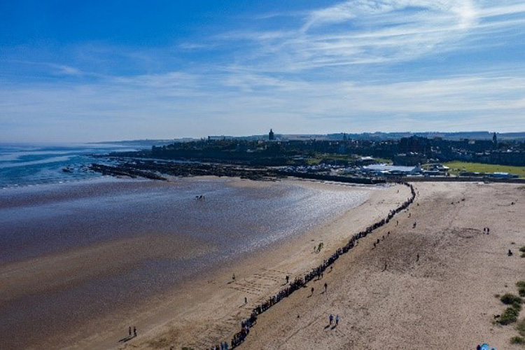 1,200 students, staff, and locals forming a line stretching across the west sands beach