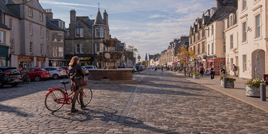 student with bike in market street