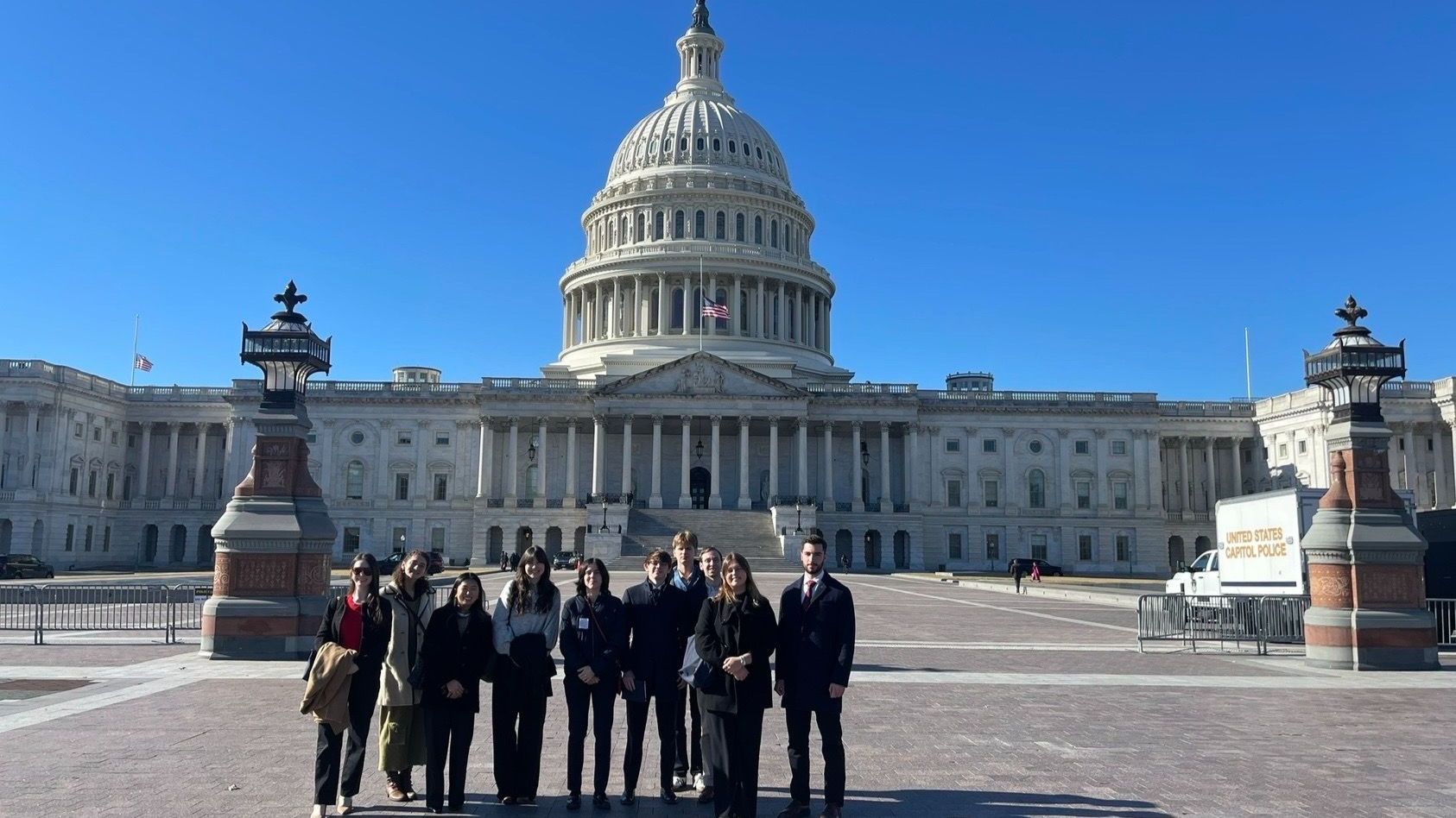 students pose for a photo outside the US Capitol building 