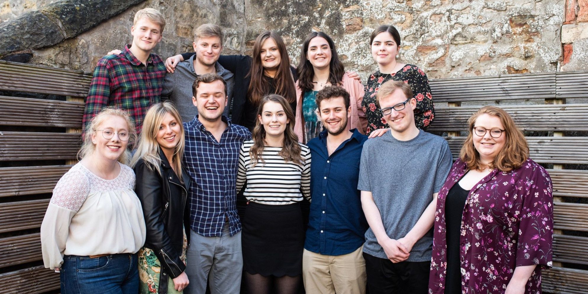 The 2018 charities committee pose smiling for a group photo (five on top row, seven on bottom row). Jessica stands at the bottom centre. 
