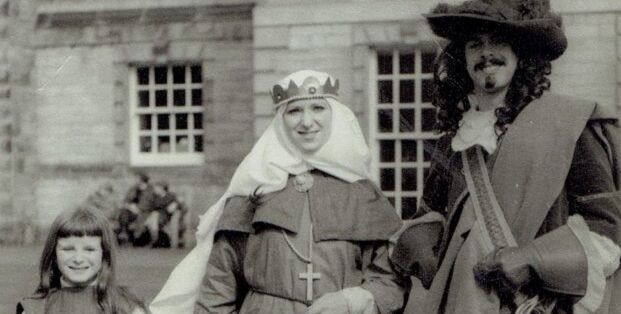 Black and white photographs taken in 1972, showing St Andrews students and a young girl dressed in costume as a king, queen and page as part of the Kate Kennedy Spring Procession Black and white photographs taken in 1972, showing St Andrews students and a young girl dressed in costume as a king, queen and page as part of the Kate Kennedy Spring Procession