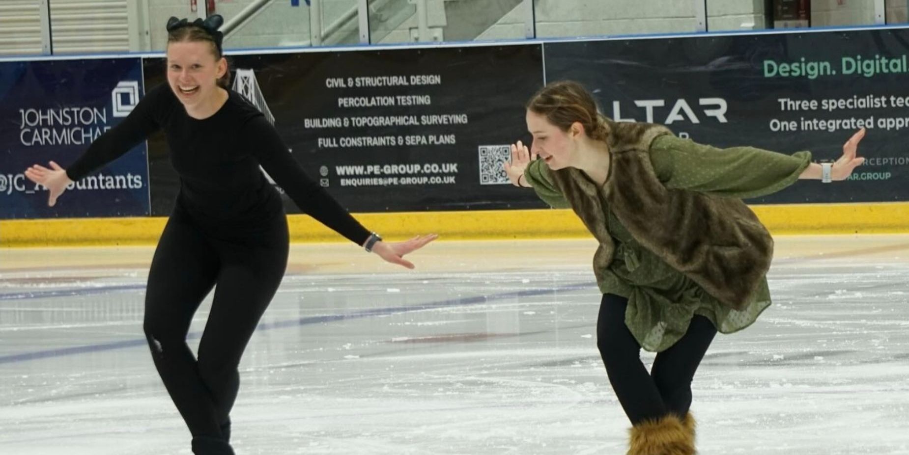 Two student figure skaters on the ice Two student figure skaters on the ice